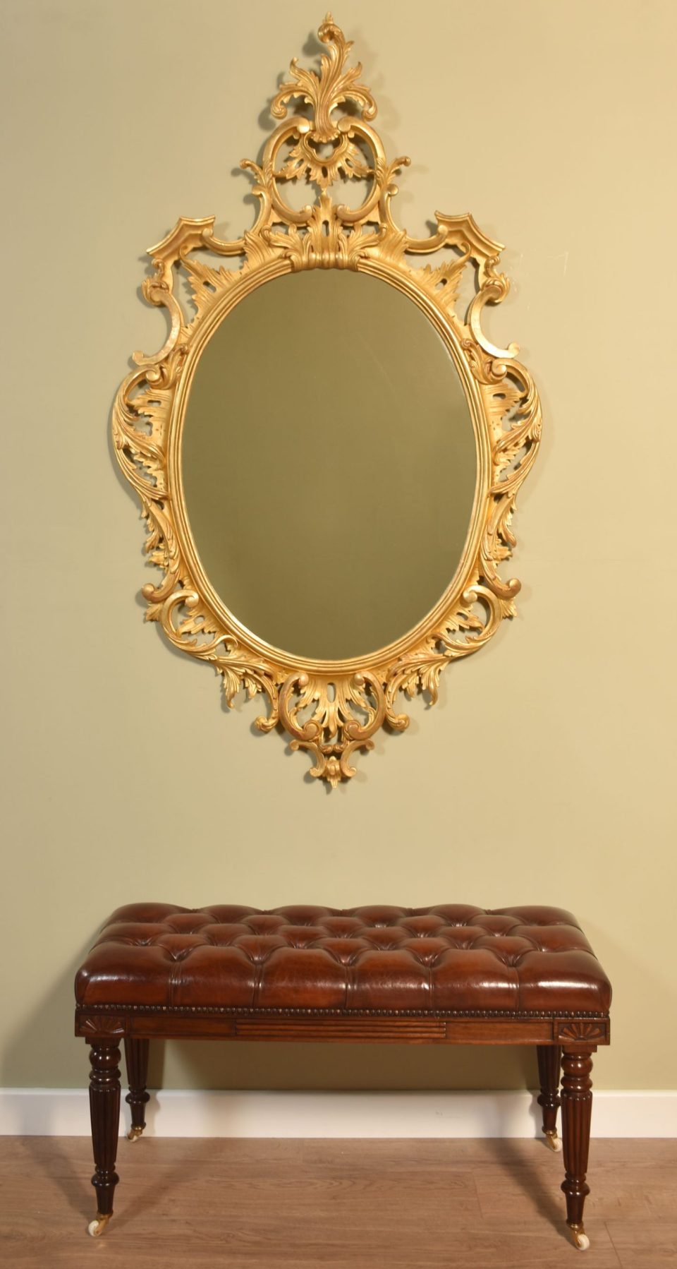 Carved gilt-wood oval wall mirror