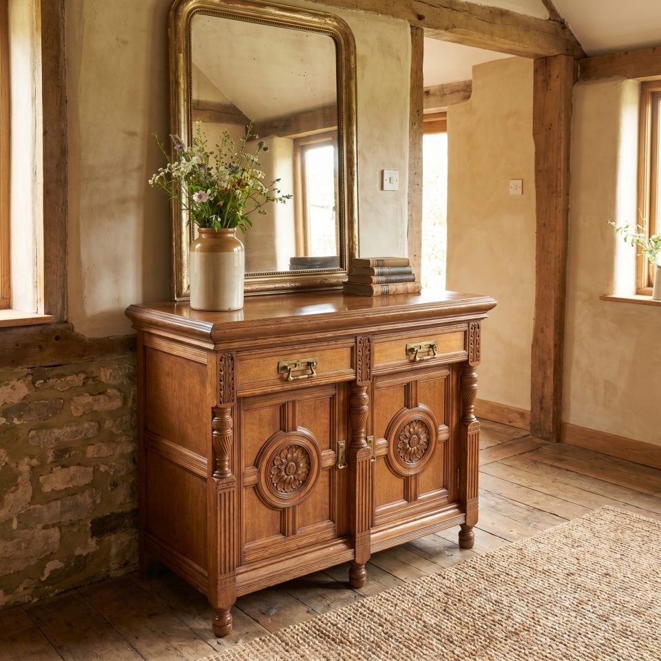 Carved oak two door sideboard by Maple and Co