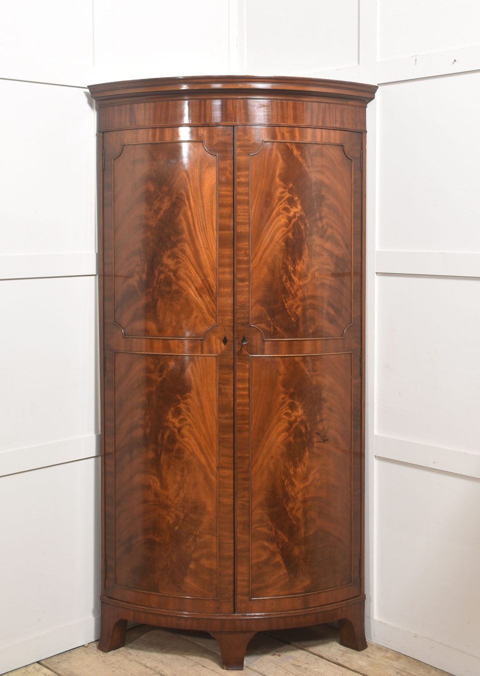 Early 20th Century Figured Mahogany Bowfront Corner Wardrobe
